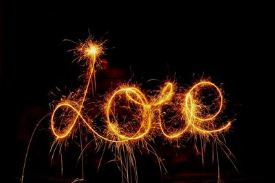 Close-up of illuminated firework display against black background