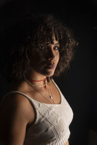 Vertical portrait of a happy woman against black background. 