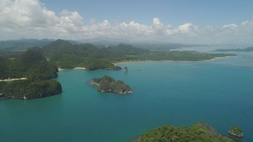 High angle view of sea and trees against sky