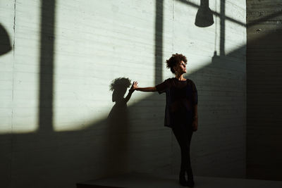 Woman sunbathing inside a building