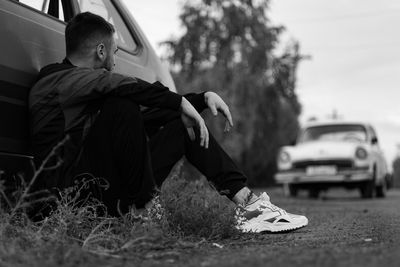 Low angle view of young woman in car