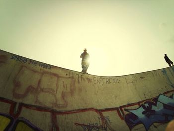 Low angle view of young woman standing