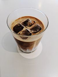 High angle view of coffee in glass on table