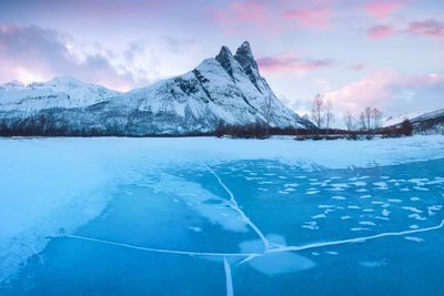 Scenic view of snowcapped mountains against sky during winter