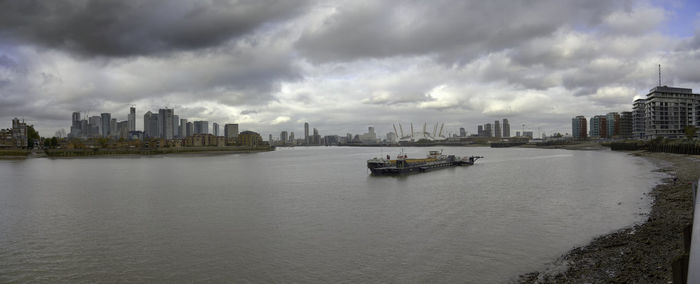 Panoramic view of sea and buildings against sky