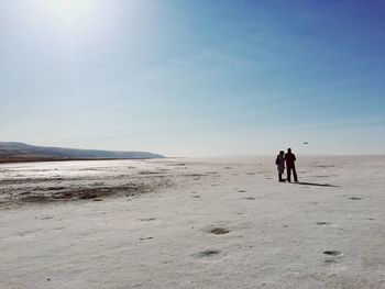People standing on sand at desert