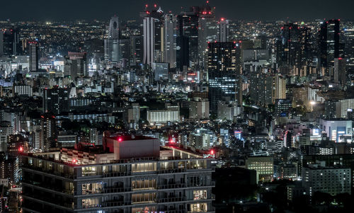 Aerial view of illuminated buildings in city at night