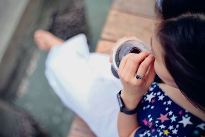 High angle view of woman holding camera