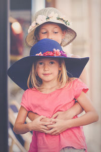 Portrait of cute girl held by sister