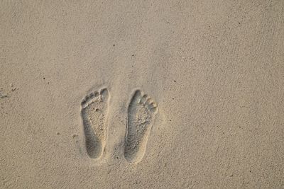 High angle view of footprints on sand