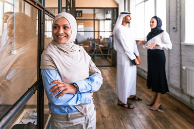 Portrait of smiling couple standing in office