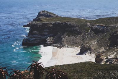 High angle view of rock formation in sea against sky