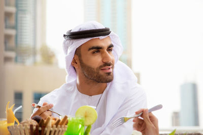 Portrait of young man holding ice cream