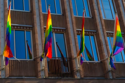 Low angle view of rainbow flags against building