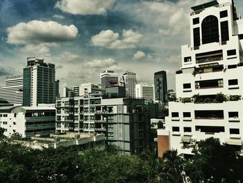 Buildings against cloudy sky