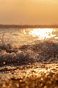 Water splashing in sea during sunset