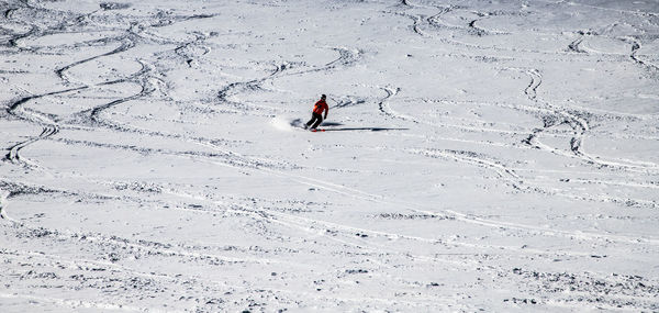 High angle view of person skiing on snowcapped field