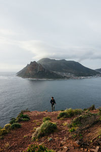 Man at sea against sky