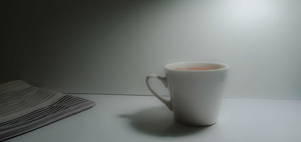 Close-up of coffee cup on table