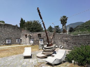 Plants growing on old building against sky