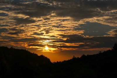 Landscape of silhouette trees and sunset with clouds