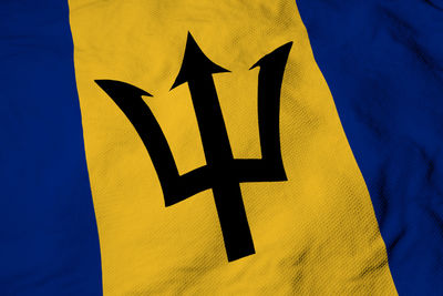 Close-up of yellow flag on blue background