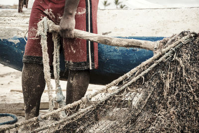 Fishermen taking the big net to the colony.