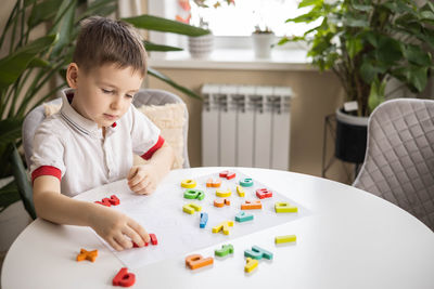 Boy painting on table