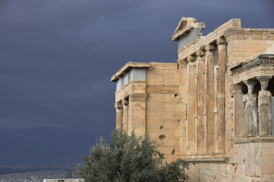 Acropolis of athens against cloudy sky
