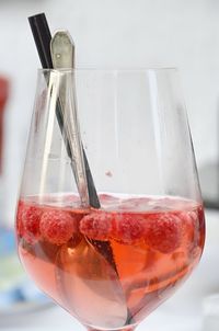 Close-up of drink with raspberry in glass