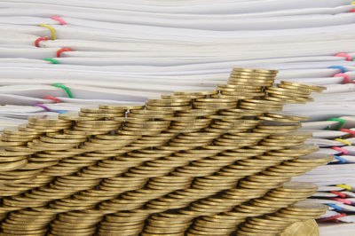 Stack of coins against papers