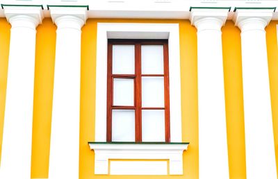 Low angle view of yellow window on building