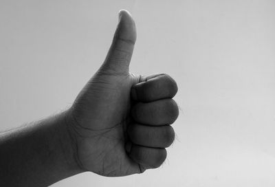 Close-up of human hand against white background