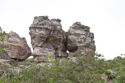 Low angle view of rock formation against clear sky