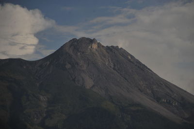 Low angle view of volcanic mountain against sky