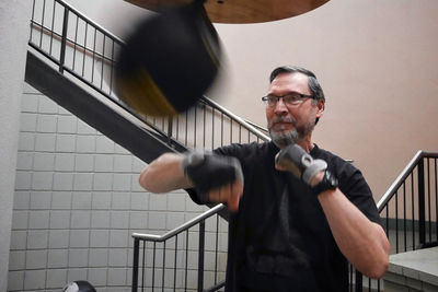 Man practicing boxing against steps