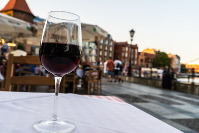 Close-up of wine in glass on table at restaurant against sky