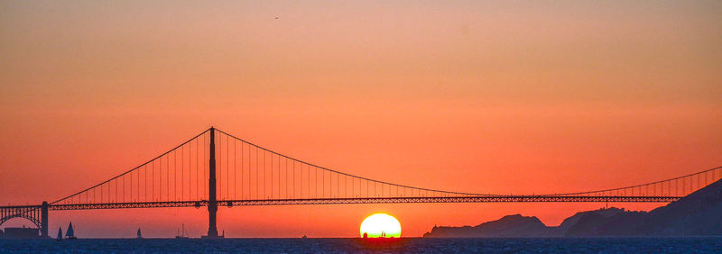 View of suspension bridge against sky during sunset