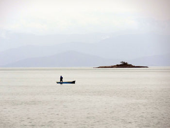 Scenic view of sea and mountains against sky