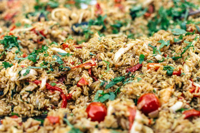 Dish of rice, herbs and vegetables close up