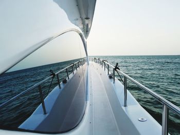 Boat sailing in sea against sky