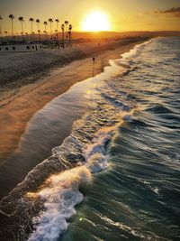 Scenic view of beach against sky during sunset