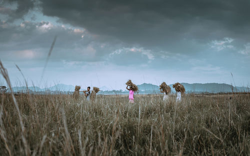 People on field against sky