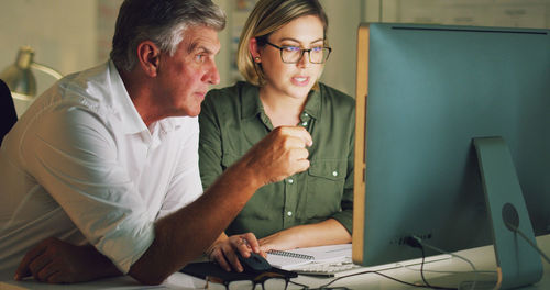 Side view of man using laptop at home