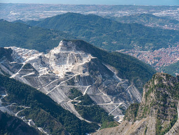 View of the carrara marble quarries and the transport trails carved into the side of the mountain.