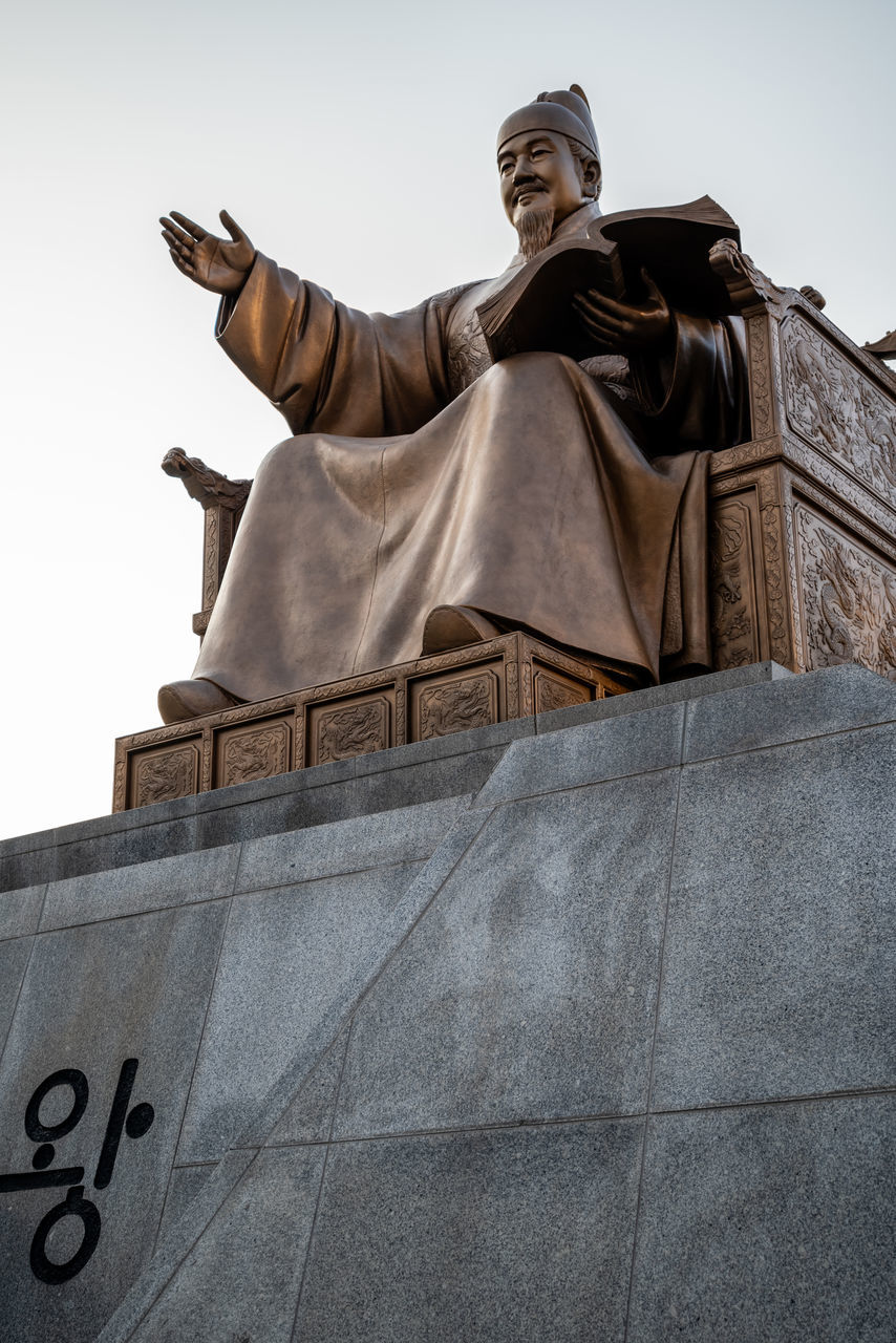 statue, sculpture, architecture, monument, human representation, low angle view, history, the past, art, representation, travel destinations, male likeness, memorial, sky, craft, travel, temple, bronze sculpture, built structure, person, nature, day, outdoors, building exterior, city