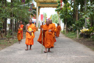 Rear view of people walking in temple