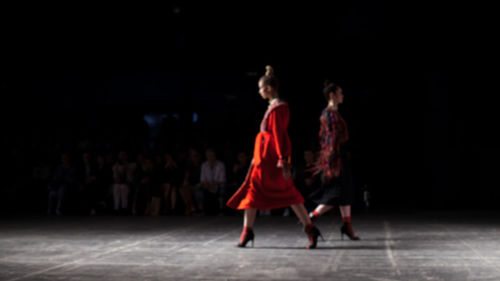 Rear view of women dancing at music concert