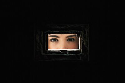 Close-up of woman seen through hole