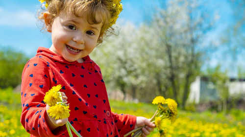 Portrait of cute girl holding flower